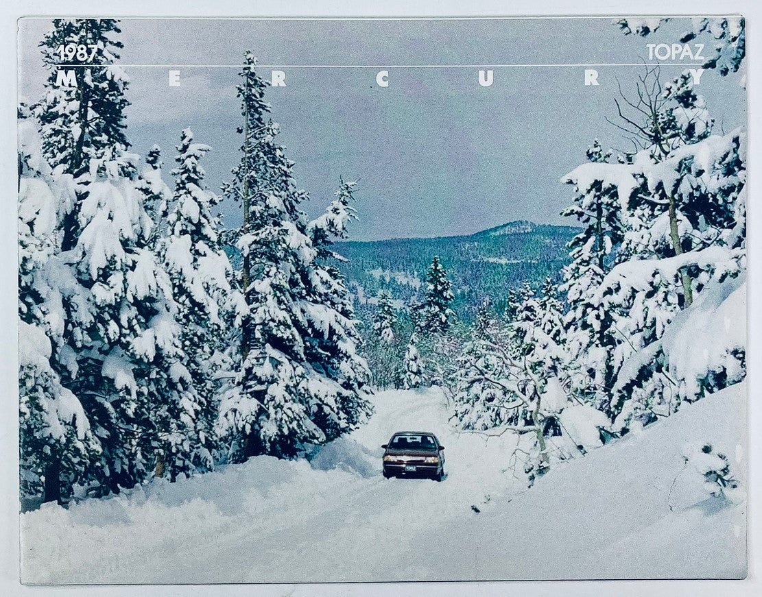 1987 Mercury Topaz full line dealer showroom sales brochure featuring a vintage car driving through a snow-covered forest.