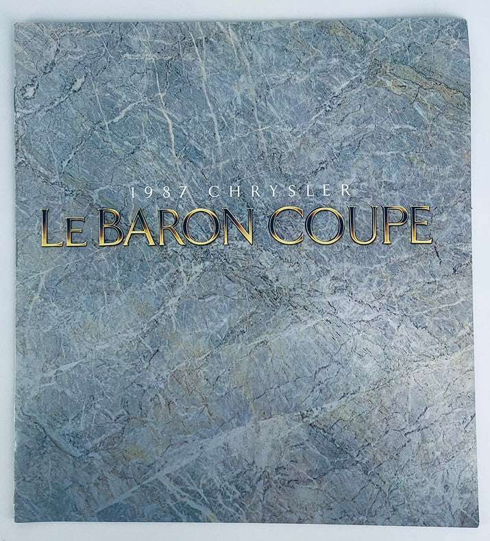 1987 Chrysler Le Baron Coupe Dealer Showroom Sales Brochure cover showcasing elegant design features with a marble-like background.