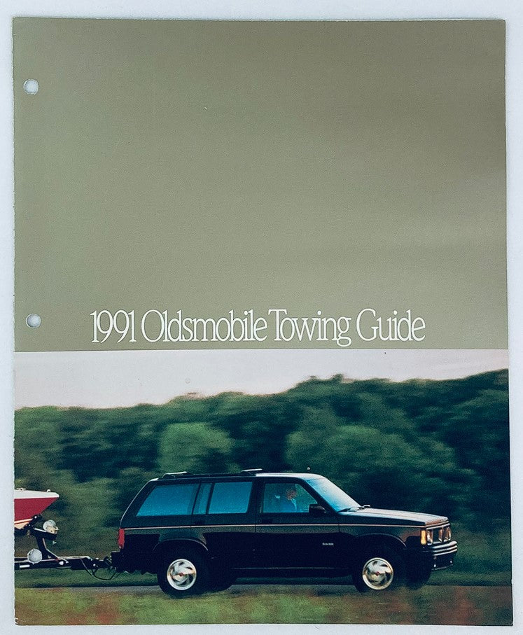 1991 Oldsmobile Towing Dealer Showroom Sales Brochure Guide Catalog featuring a black SUV towing a boat, highlighting towing capabilities.