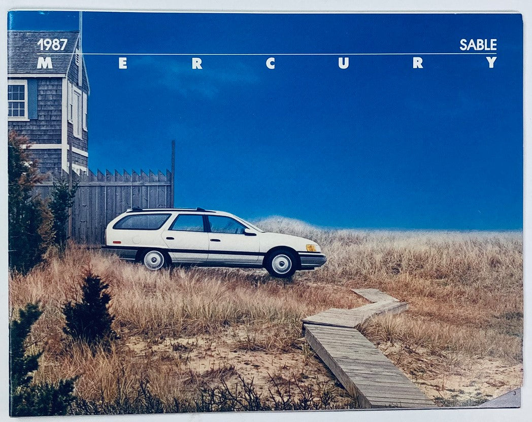 1987 Mercury Sable Full Line Dealer Showroom Sales Brochure Guide Catalog featuring a white Mercury Sable parked on a sandy path in a grassy area with a house in the background.
