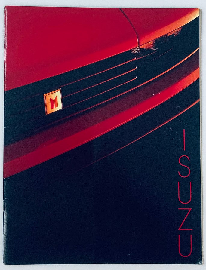 1984 Isuzu Full Line Dealer Showroom Sales Brochure showcasing the iconic Isuzu logo against a sleek red car background, perfect for collectors and automotive enthusiasts.
