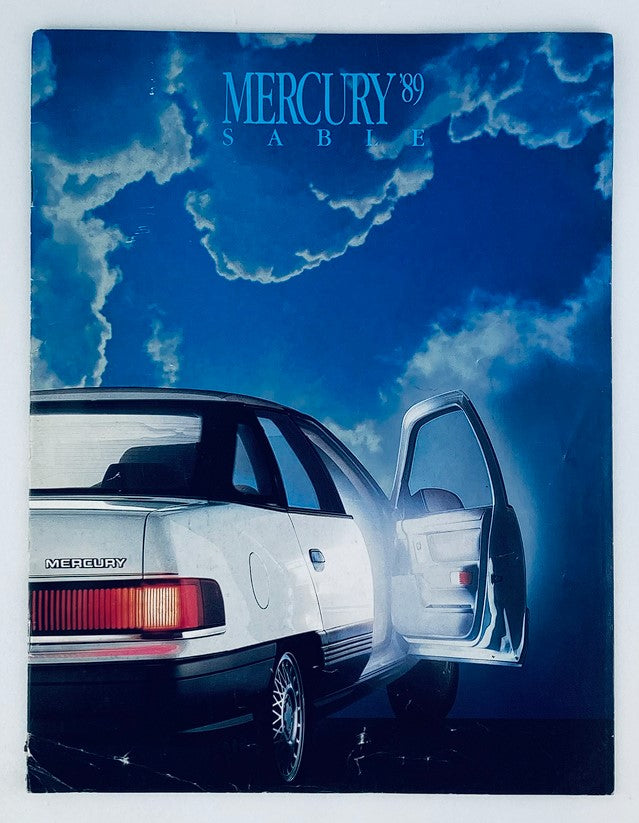 Cover of the 1989 Mercury Sable Dealer Showroom Sales Brochure Guide Catalog featuring a stylish white Mercury Sable car against a dramatic sky backdrop.