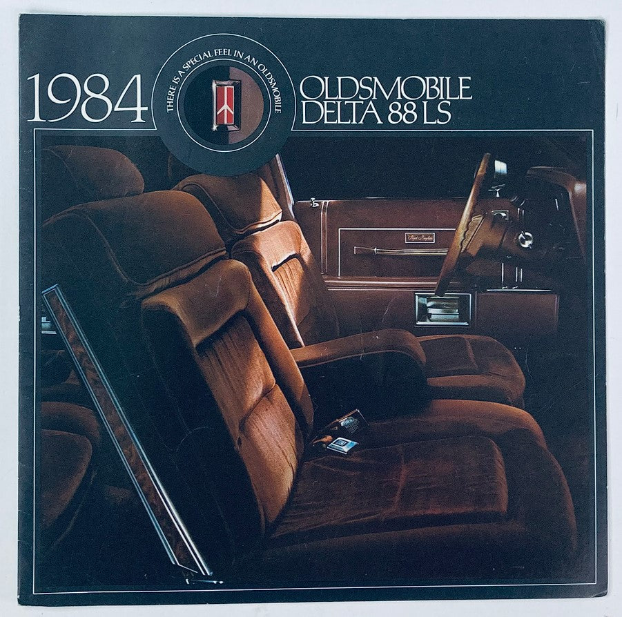 1984 Oldsmobile Delta 88 LS Dealer Showroom Sales Brochure featuring an interior photo showcasing the plush seating and luxurious design of the car's interior.
