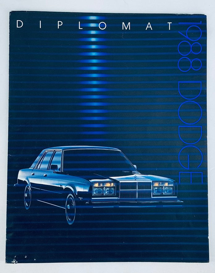 1988 Dodge Diplomat Dealer Showroom Sales Brochure Guide Catalog cover featuring a sleek blue Dodge Diplomats on a blue striped background.