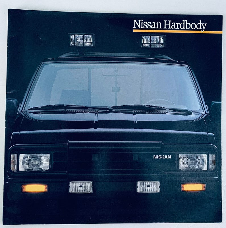Front view of the 1989 Nissan Hardbody from the Dealer Showroom Sales Brochure Guide Catalog, showcasing the vehicle's distinct headlights and design features.