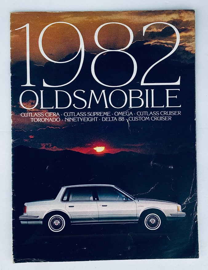 Cover of the 1982 Oldsmobile Cutlass Ciera Dealer Showroom Sales Brochure, featuring the Oldsmobile logo and a classic car against a backdrop of a sunset.
