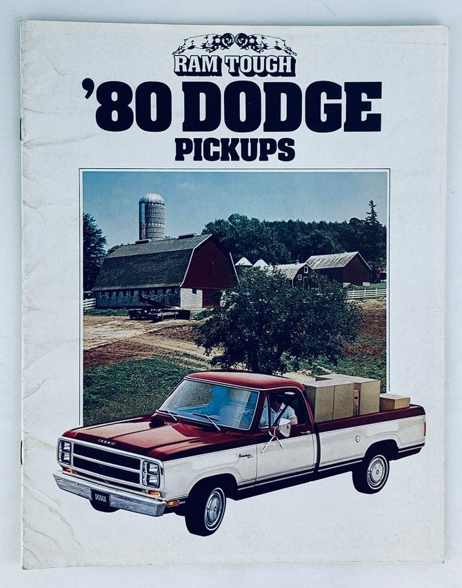 1980 Dodge Pickups Dealer Showroom Sales Brochure featuring a classic pickup truck parked in front of a farmstead, showcasing the rural landscape and design aesthetics of the era.