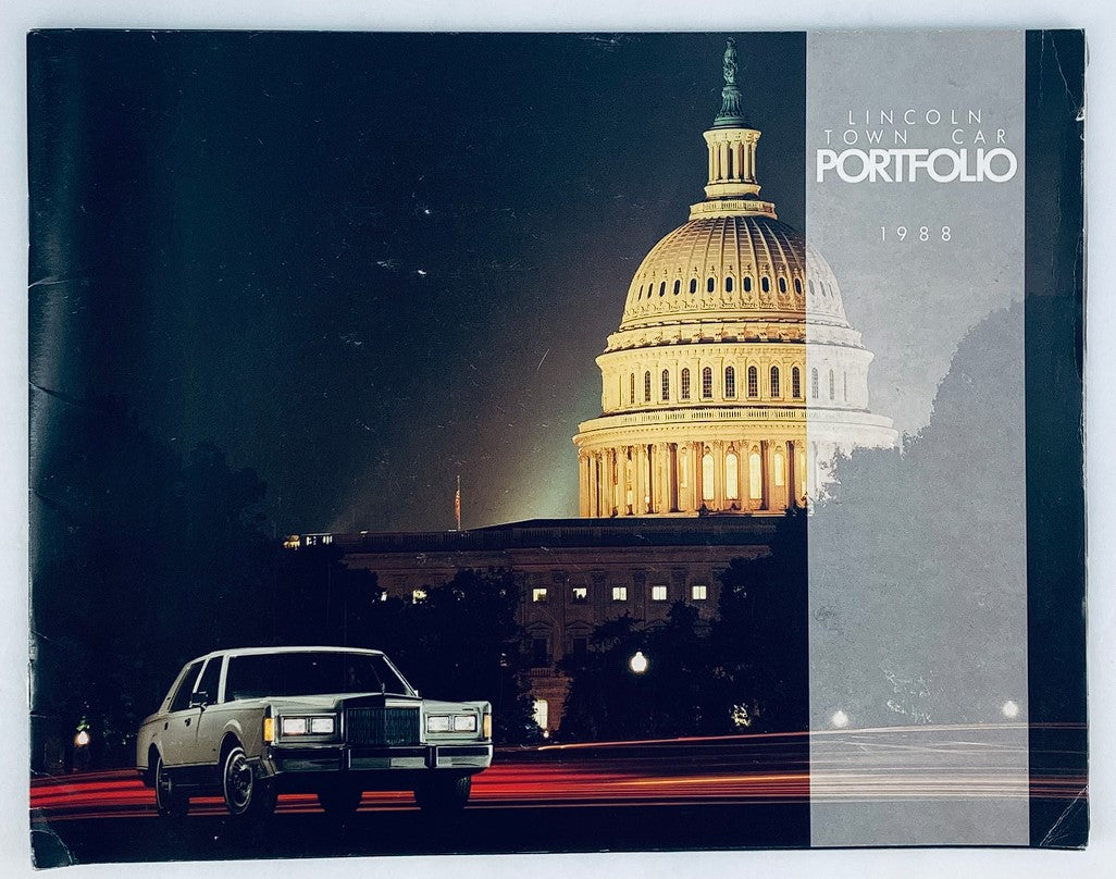 Cover of the 1988 Lincoln Town Car Portfolio Dealer Showroom Sales Brochure Guide Catalog, featuring a Lincoln Town Car in front of an iconic building at night, showcasing the elegance of the 1988 model.