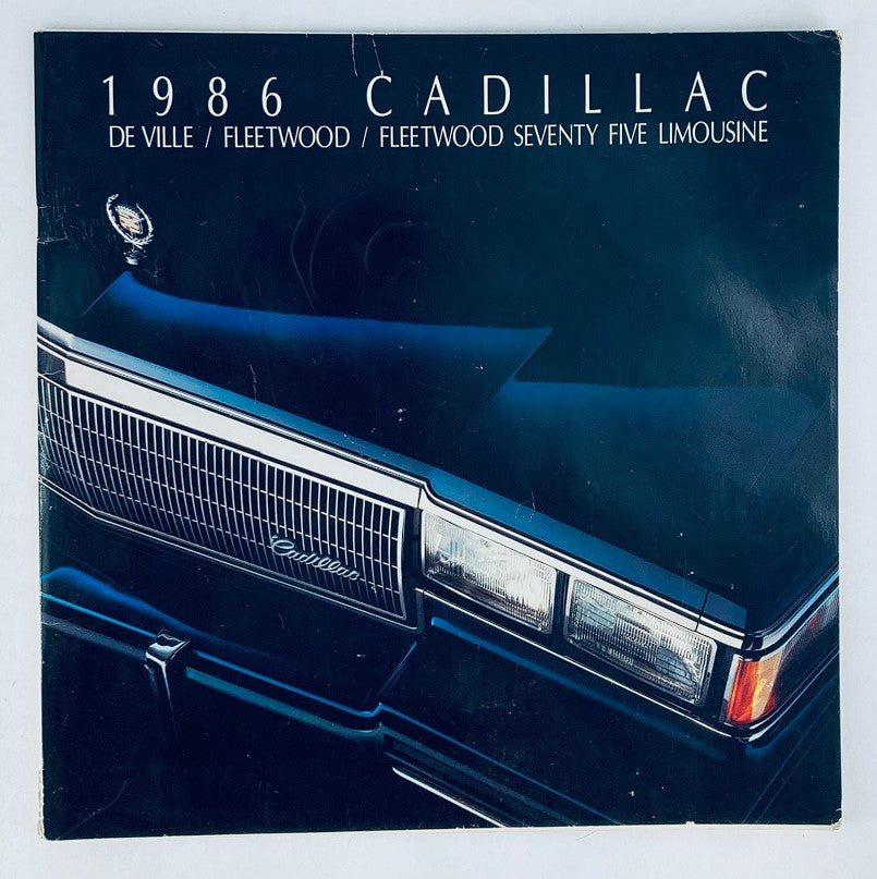 1986 Cadillac De Ville, Fleetwood Dealer Showroom Sales Brochure Guide Catalog cover featuring the sleek design of the car's front end, highlighting the luxury details and emblem.