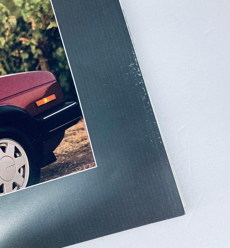 Close-up of the 1988 Volkswagen Jetta Dealer Showroom Sales Brochure Guide Catalog showcasing the design details of the Jetta's front end and the brochure's edge.
