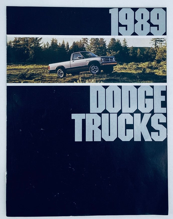 1989 Dodge Trucks Lineup Dealer Showroom Sales Brochure featuring a classic Dodge truck amidst a natural landscape, showcasing the exterior design and branding.