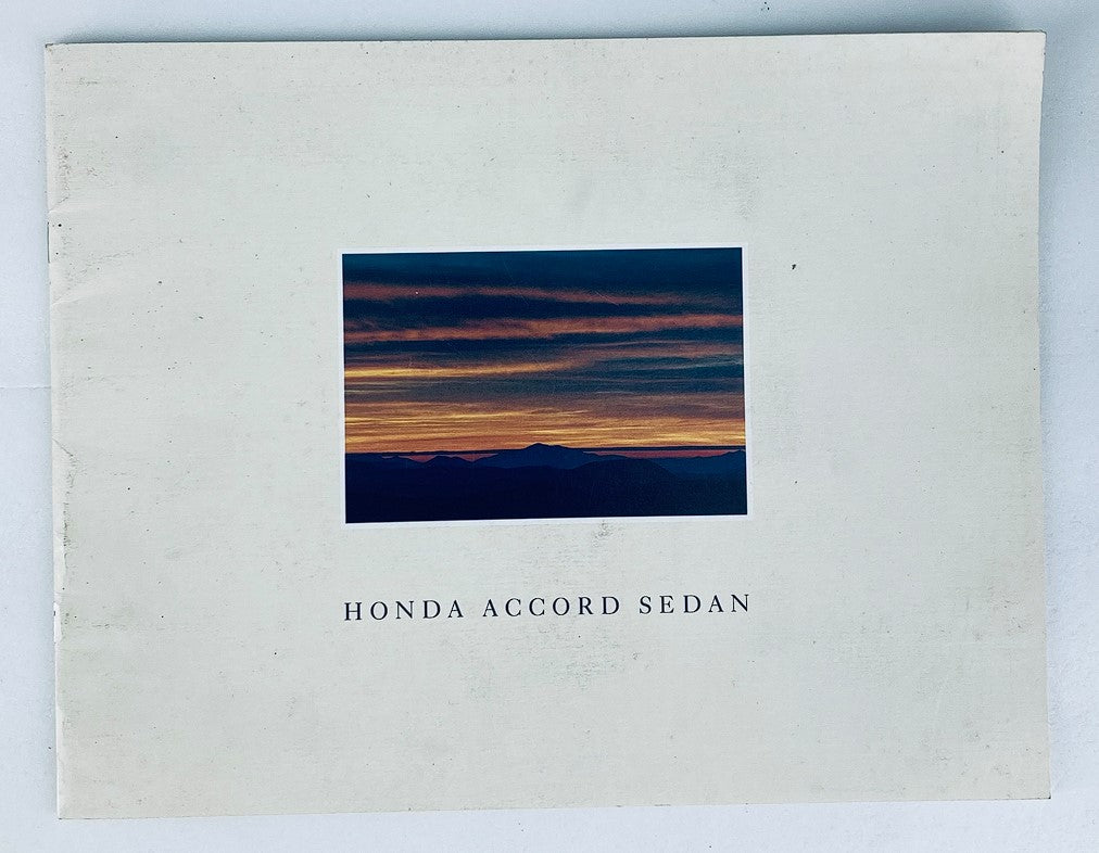 Cover of the 1990 Honda Accord Sedan Dealer Showroom Sales Brochure Guide Catalog featuring a scenic sunset over mountains.