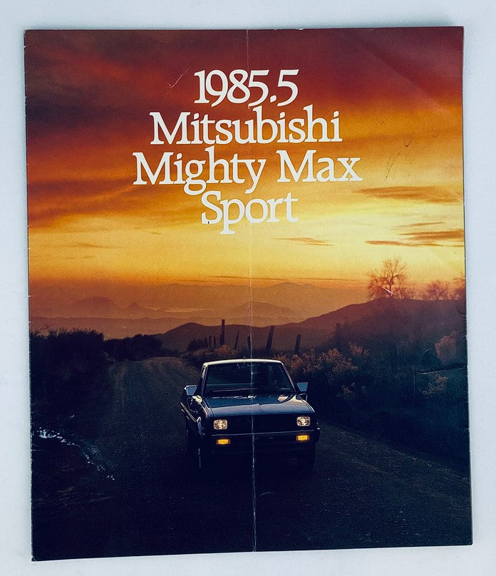 1985 Mitsubishi Mighty Max Sport Dealer Showroom Sales Brochure featuring the truck on a scenic road at sunset, highlighting the vehicle's design and showcasing the brochure's cover.
