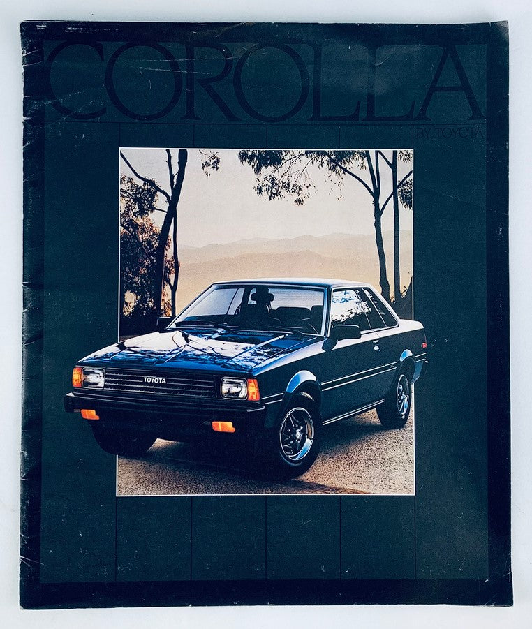 Cover image of the 1983 Toyota Corolla Lineup Dealer Showroom Sales Brochure Guide Catalog, featuring a classic black Toyota Corolla on a scenic road background.