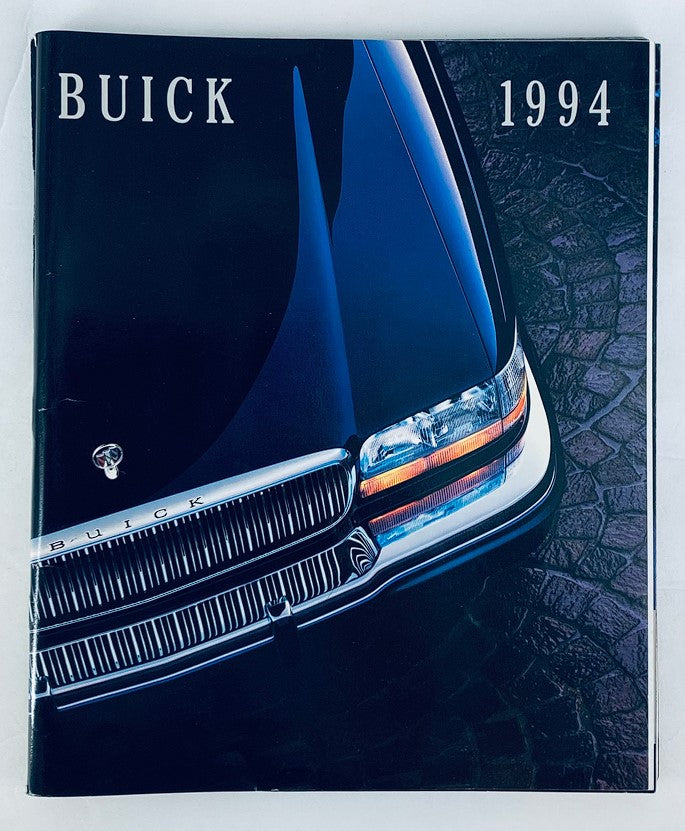 1994 Buick Lineup Dealer Showroom Sales Brochure showcasing the sleek front view of a Buick vehicle, highlighting its elegant design and iconic grille.
