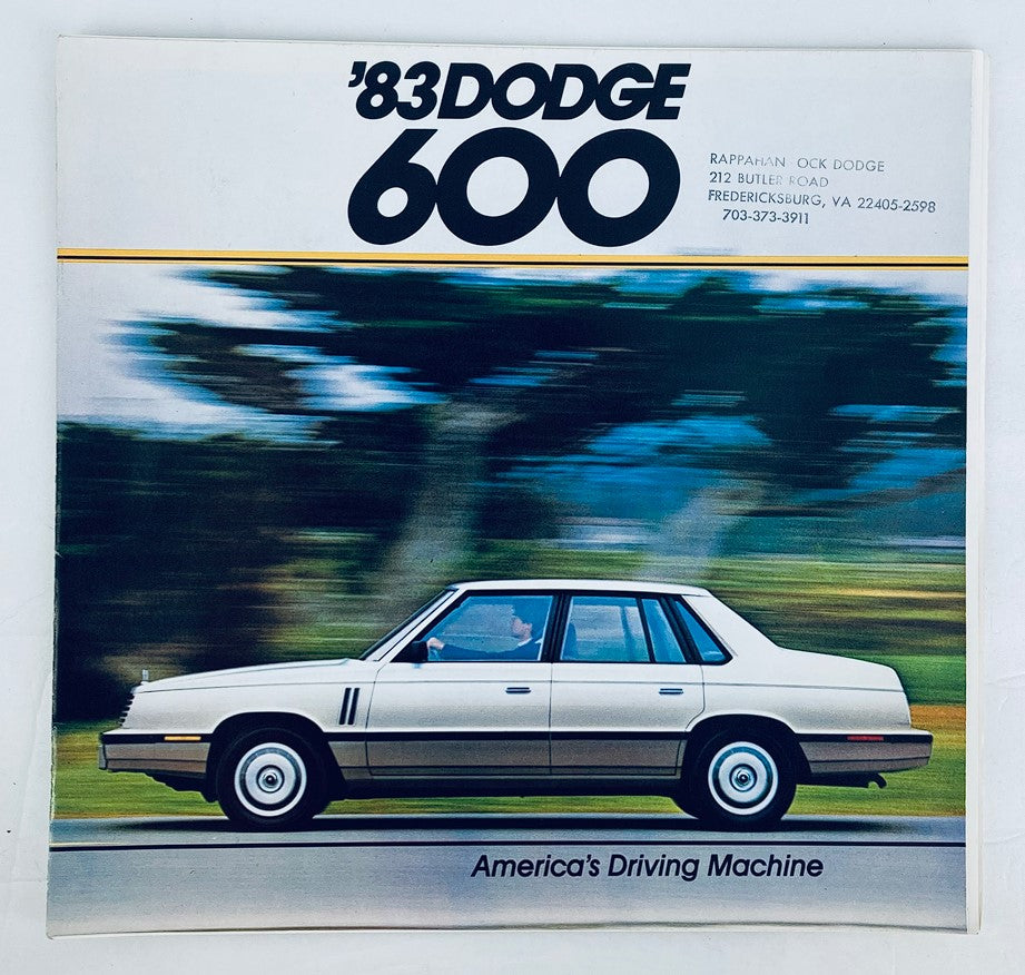 1983 Dodge 600 Dealer Showroom Sales Brochure Guide Catalog featuring a white Dodge 600 sedan in motion with a blurred background, emphasizing the car's sleek design and promoting it as 'America's Driving Machine'.