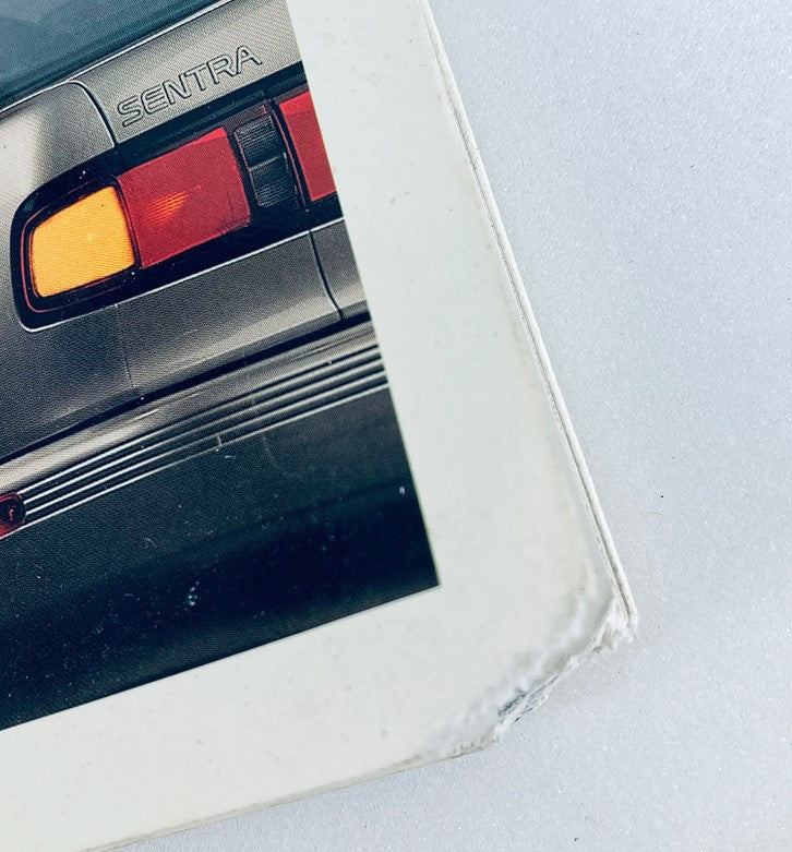 Close-up view of the rear light detail of the 1991 Nissan Sentra, showcasing the iconic SENTRA branding on the vehicle.