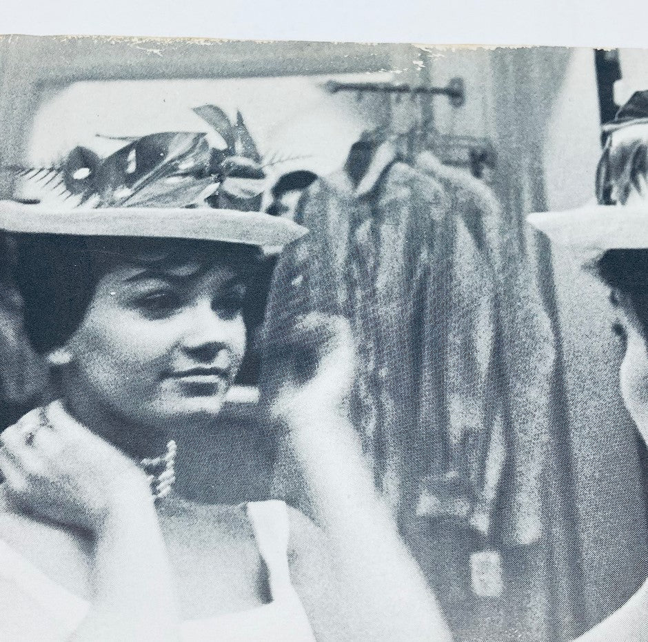 Delores Wells adjusting a stylish hat in black and white, captured in an elegant moment from the June 1960 Playboy Magazine.