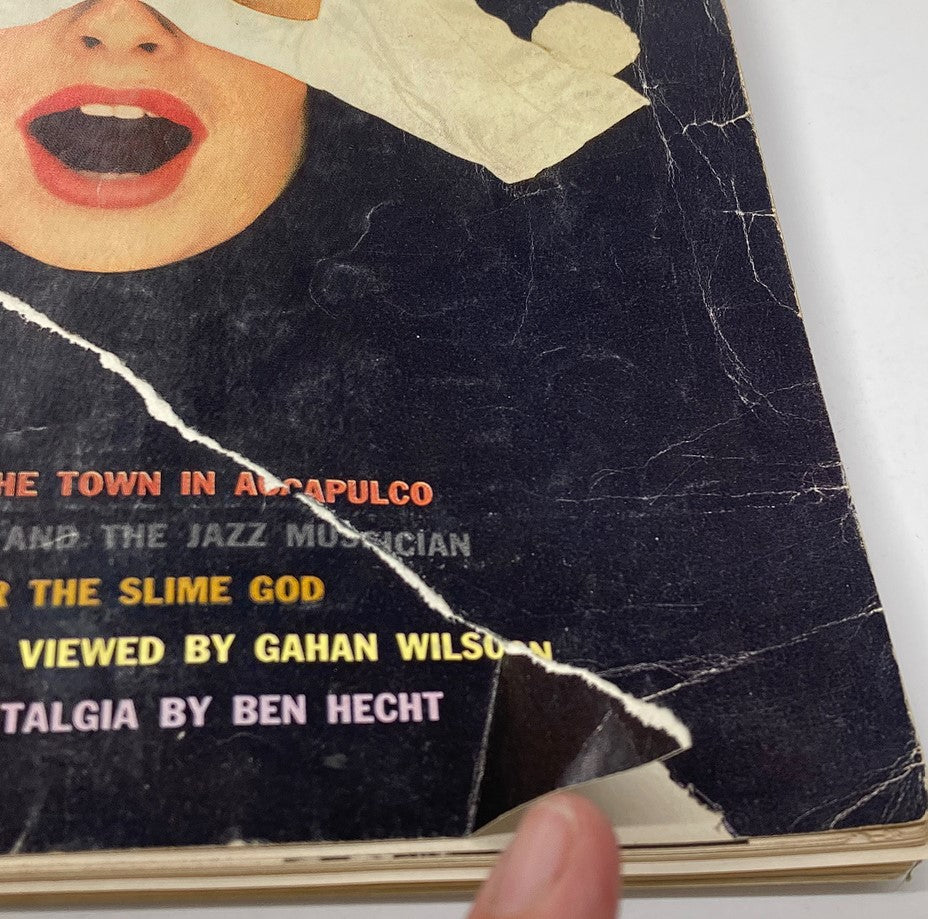 Close-up of the cover art of VTG Playboy Magazine November 1960, showcasing details of a woman's face and hands in dramatic pose.