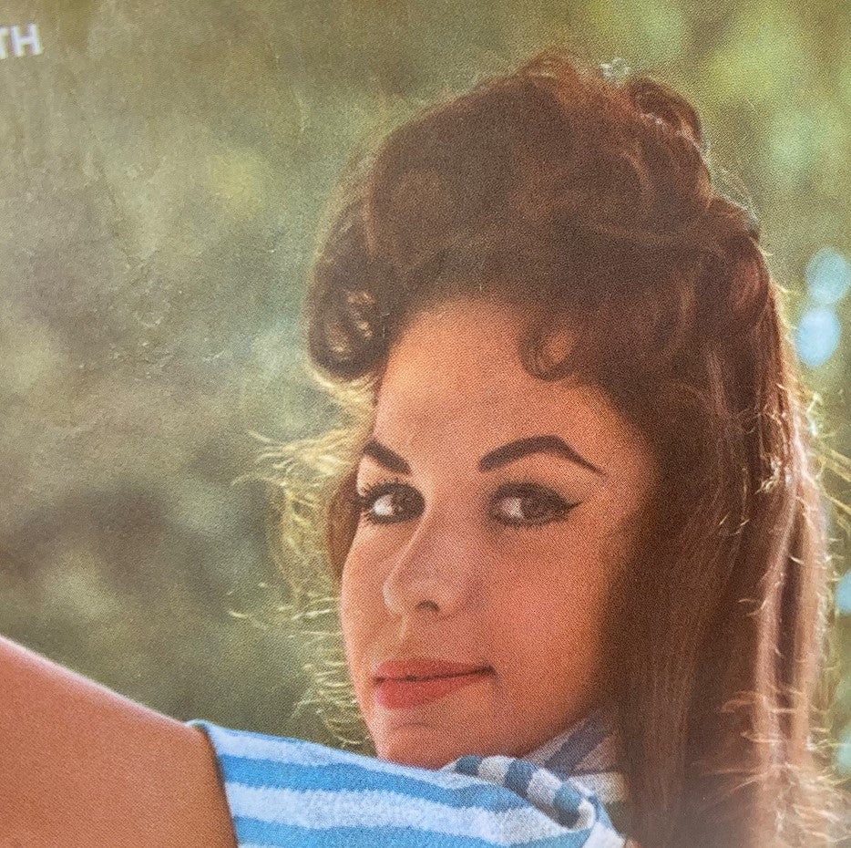 Close-up image from VTG Playboy Magazine March 1961 displaying a vintage portrait of a young woman with stylish hair and makeup, embodying the '60s fashion.
