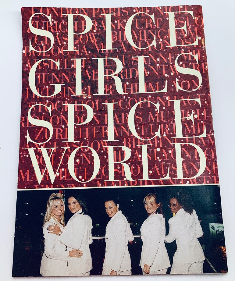 1998 Spice Girls - Spice World The Tour Program cover featuring the title in bold text and a photo of the five Spice Girls in white outfits, a nostalgic representation of their 90s tour.