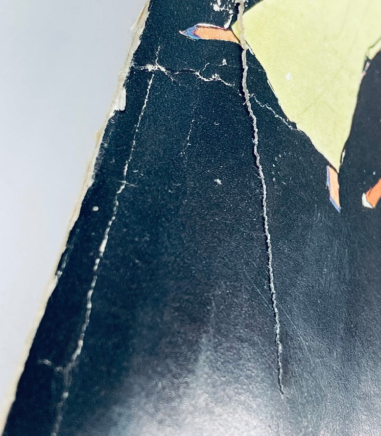 Close-up view of the front cover damage on VTG Playboy Magazine November 1962, showcasing visible creases and wear, highlighting its vintage condition.