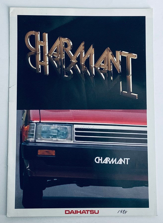 1984 Daihatsu Charmant Dealer Showroom Sales Brochure Guide Catalog featuring the Charmant logo and a red Daihatsu Charmant car on the cover.