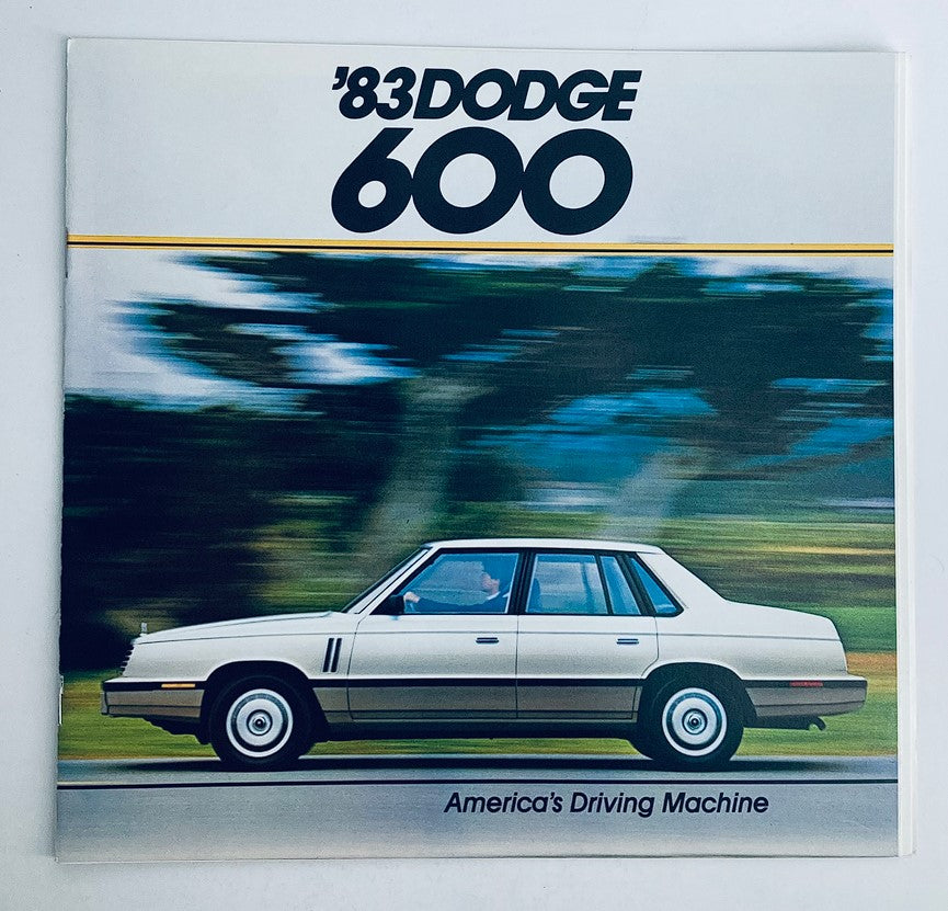 1983 Dodge 600 Dealer Showroom Sales Brochure cover showcasing the car in motion with the slogan 'America's Driving Machine', perfect for vintage automotive collectors.