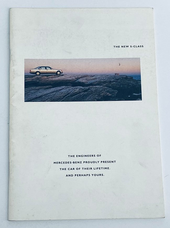 Cover of the 1991 Mercedes-Benz S-Class Dealer Showroom Sales Brochure Catalog, featuring an image of a Mercedes-Benz car on a rocky landscape with the title 'THE NEW S-CLASS'.