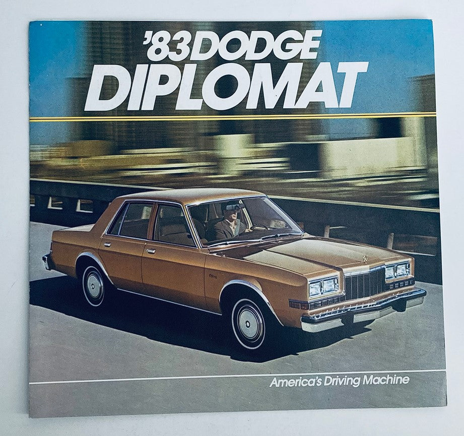 1983 Dodge Diplomat Dealer Showroom Sales Brochure showcasing a brown Dodge Diplomat parked on an urban road, highlighting its design and features as part of the promotional catalog.
