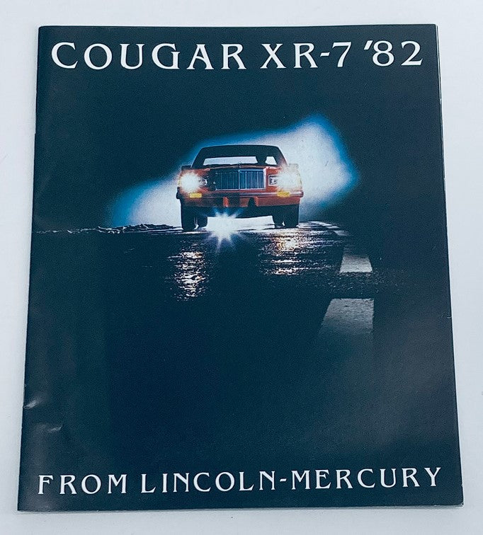 1982 Mercury Cougar XR-7 Dealer Showroom Sales Brochure featuring a dramatic image of the car front-lit on a dark road, highlighting the vehicle's design and appeal.