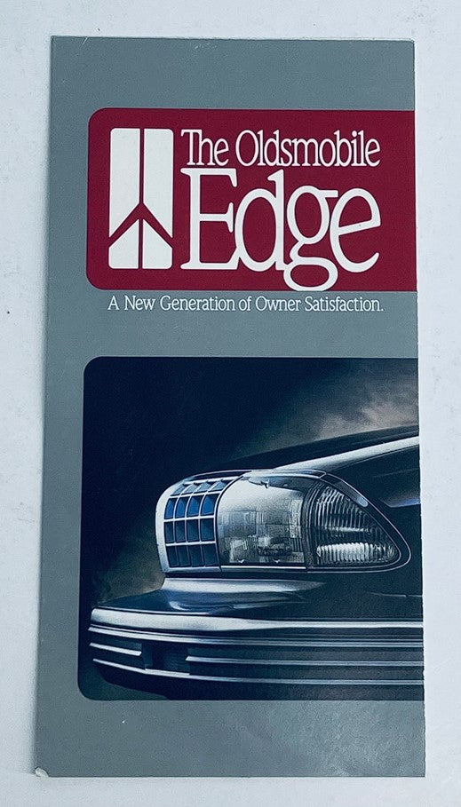 Cover of the 1990 Oldsmobile Edge Lineup Dealer Showroom Sales Brochure Guide Catalog featuring a close-up of a vehicle headlight and the Oldsmobile Edge logo.