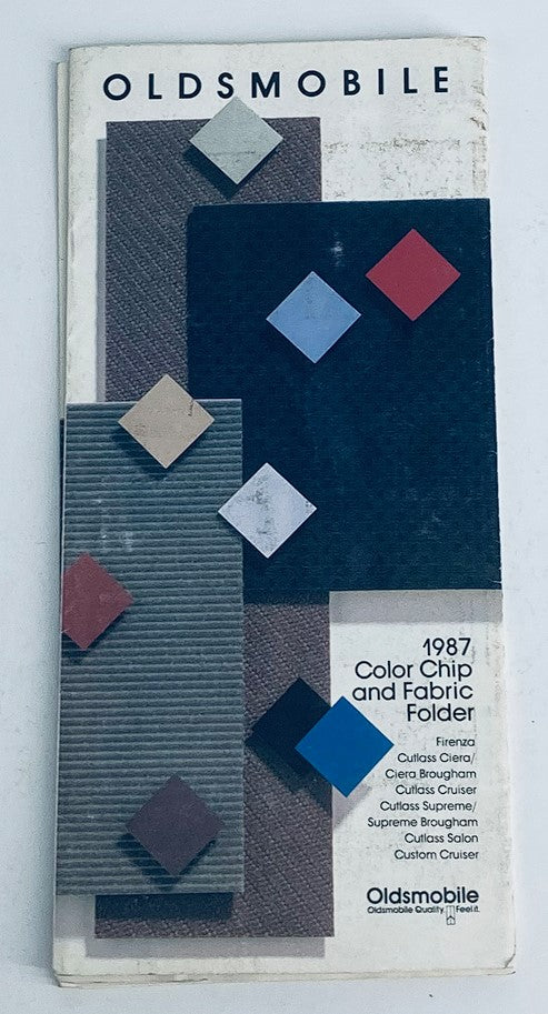 1987 Oldsmobile Fabric Folder Dealer Showroom Sales Brochure Guide Catalog cover featuring color swatches and fabric samples.
