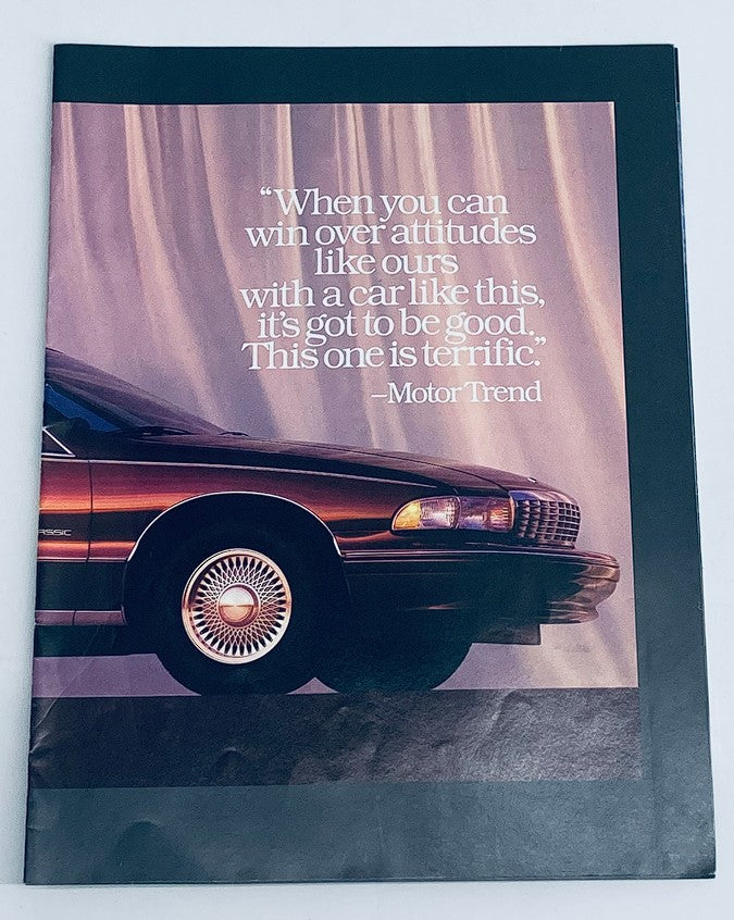 1990 Chevrolet Motor Trend Car of the Year Dealer Showroom Sales Guide Catalog cover featuring a sleek car design and a quote from Motor Trend highlighting the vehicle's excellence.