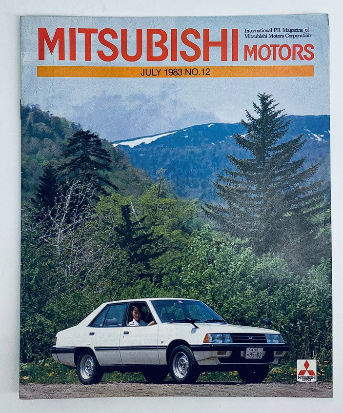 Cover of VTG Mitsubishi Motors Magazine July 1983 No. 12 featuring the Mitsubishi Lancer, displaying a scenic backdrop with a white Mitsubishi Lancer parked beside a man in the driver's seat, showcasing vintage automotive design and culture.