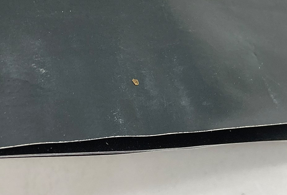 Close-up of the edge of the 1995 Oldsmobile Aurora Lineup Dealer Showroom Sales Brochure Catalog showing minor blemishes.