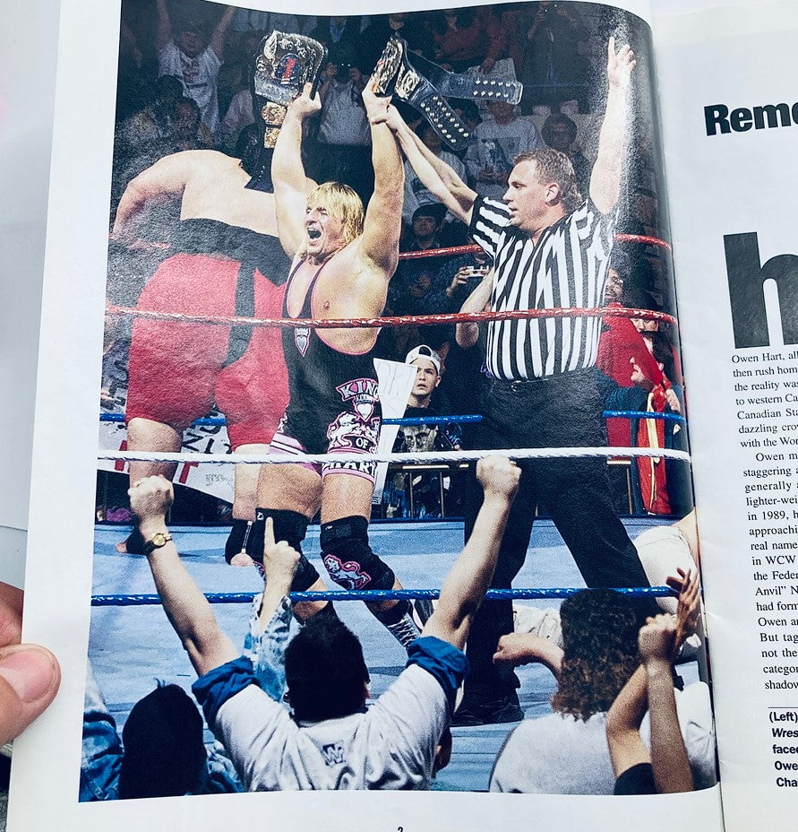 WWF World Wrestling Federation Magazine Owen Hart Tribute 1965-1999 - Owen Hart celebrating his championship victory with belts raised, surrounded by cheering fans in the wrestling ring.