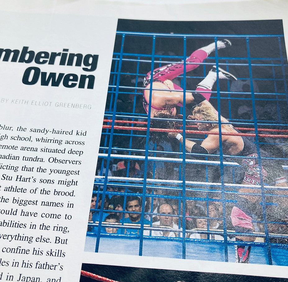 WWF World Wrestling Federation Magazine Owen Hart Tribute 1965-1999 - Action shot of Owen Hart performing a stunning move in a wrestling ring, highlighting his athleticism.