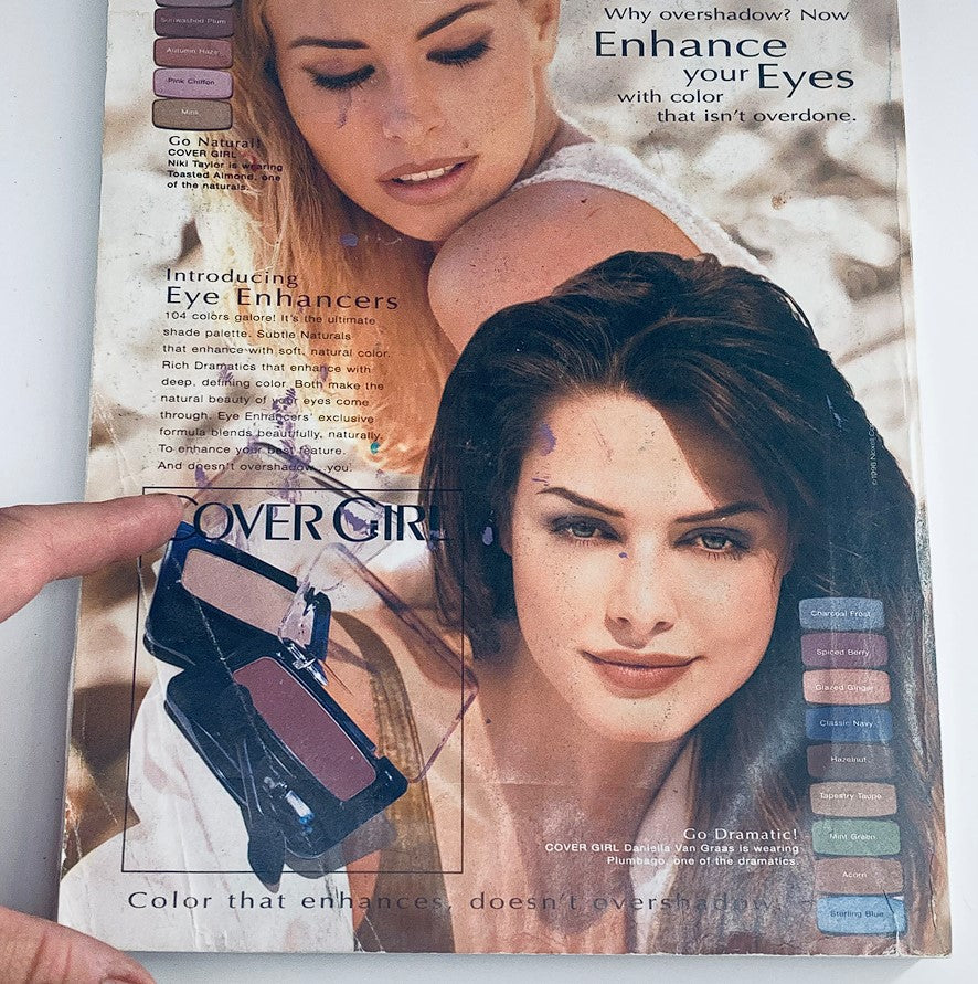 Back cover of Vogue Magazine May 1996, promoting Cover Girl makeup with two models and eye enhancers, highlighting beauty trends popular in the 90s.