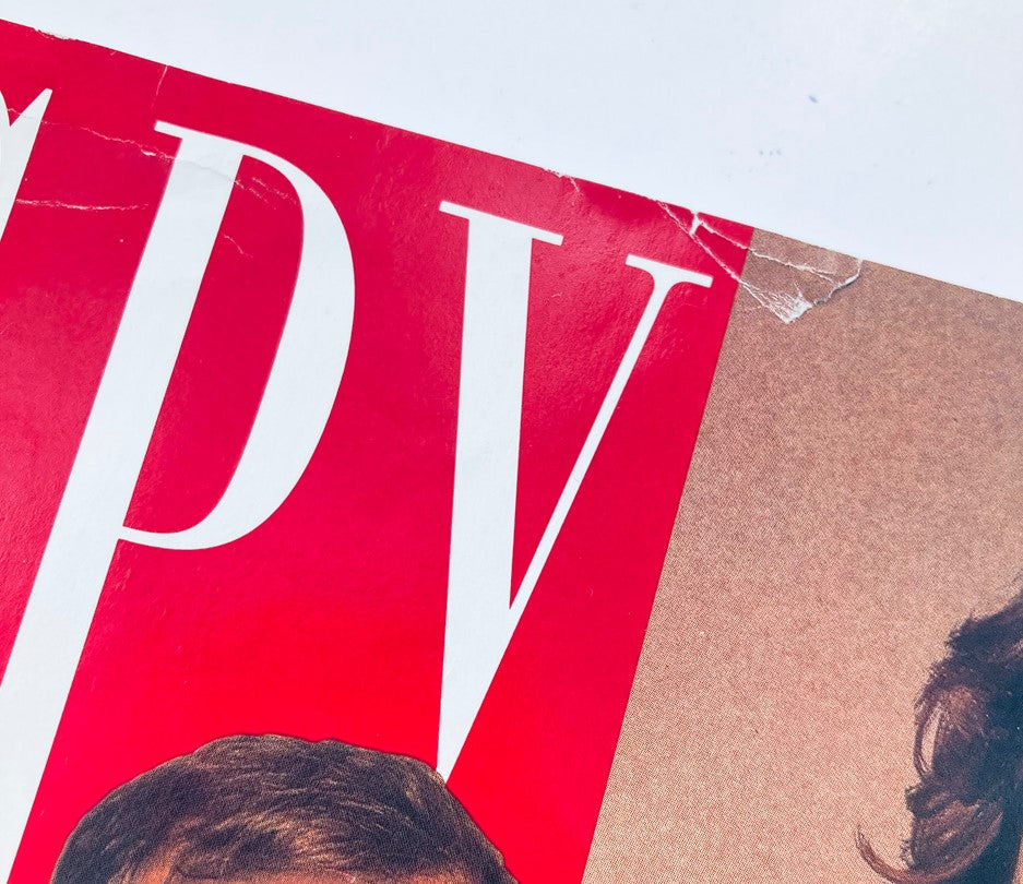 Close-up detail of the top left corner of the Spy Magazine November 1992 cover showing the magazine title and damage to the cover.
