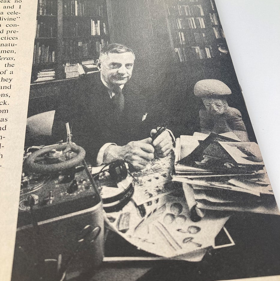A black and white image from Life Magazine showing a man in a suit working at a cluttered desk, May 13, 1957 issue.