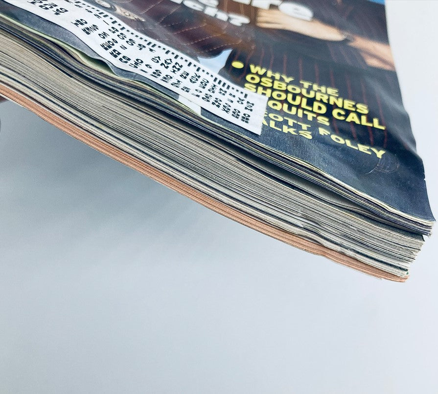 Side view of the TV Guide Magazine October 25, 2003, showing the worn edges and overall condition of the magazine, emphasizing its vintage quality and authenticity.