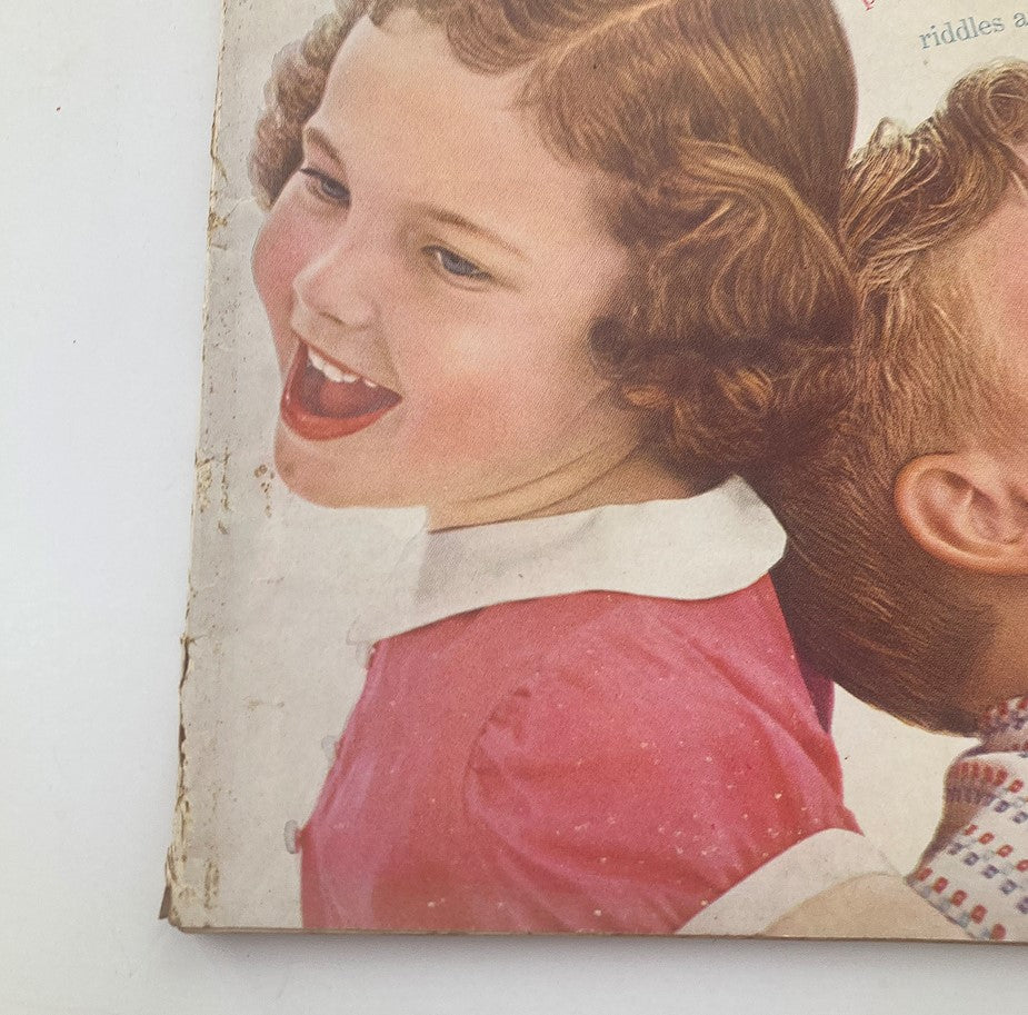 Close-up of the cover of August 1954 Woman's Day magazine featuring children laughing, highlighting the title 'It's A Lovely Rainy Day' and the nostalgic design elements.