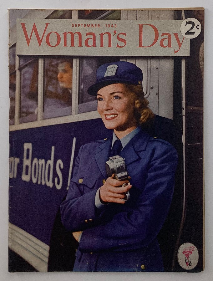 Cover of VTG Woman's Day Magazine from September 1943, featuring a smiling woman in a blue uniform holding a camera, emphasizing women's roles during World War II.