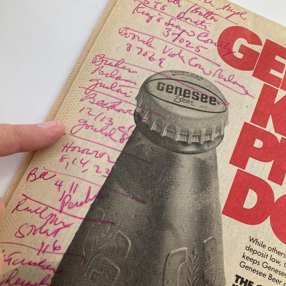 Detail of the Genesee Beer advertisement from VTG Metroland Newspaper October 13 1983 #208 Stan Getz Troy Bank Music Hall, showcasing handwritten notes beside the bottle cap.