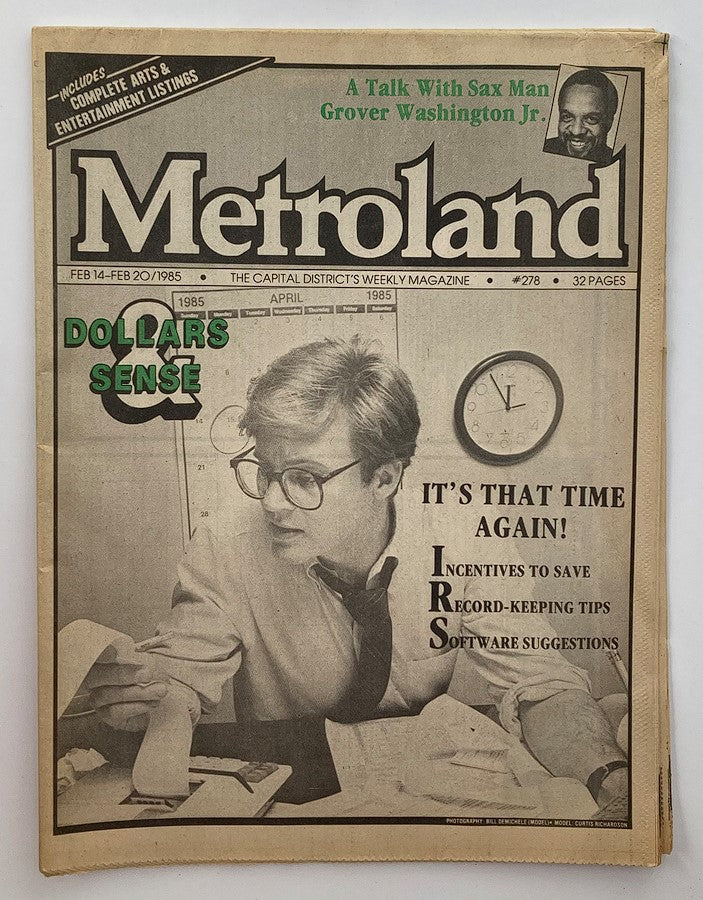 VTG Metroland Newspaper February 14 1985 #278 featuring a cover story with saxophonist Grover Washington Jr. The magazine showcases a young man with glasses working on papers, emphasizing tax season tips, alongside vintage advertisements and the 1980s cultural landscape.