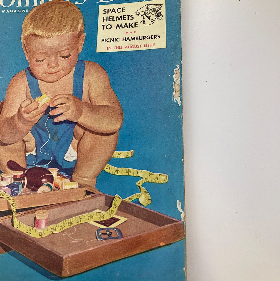 Close-up of the cover of VTG Woman's Day Magazine August 1953, titled The Eye of The Beholder, showing a young child engaged in crafting with colorful supplies and measuring tape.