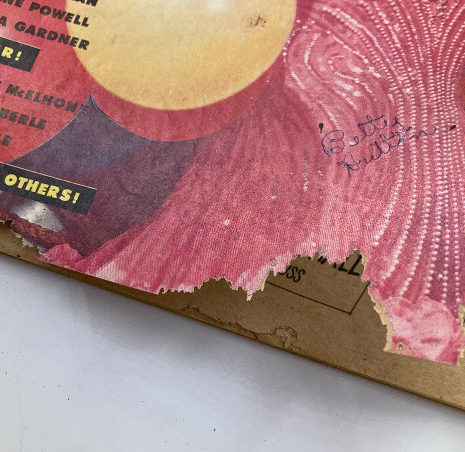 Close-up of the damaged edge of the VTG Movie Pix Magazine February 1952 cover, highlighting wear and a handwritten signature of Betty Hutton.