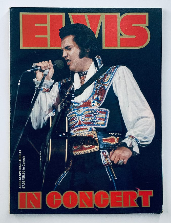 VTG 1979 Elvis in Concert by John Reggero featuring Elvis Presley on stage in a colorful outfit with a microphone, showcasing his charisma and style.