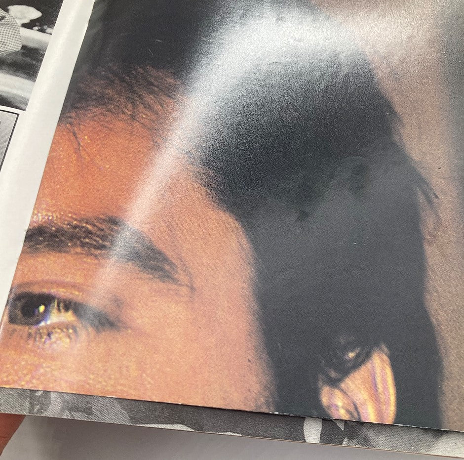Close-up of an Elvis Presley magazine page from the Elvis International Forum Winter 1993 Vol 6 #4 with focus on a portion of the image, showcasing detailed textures and colors.